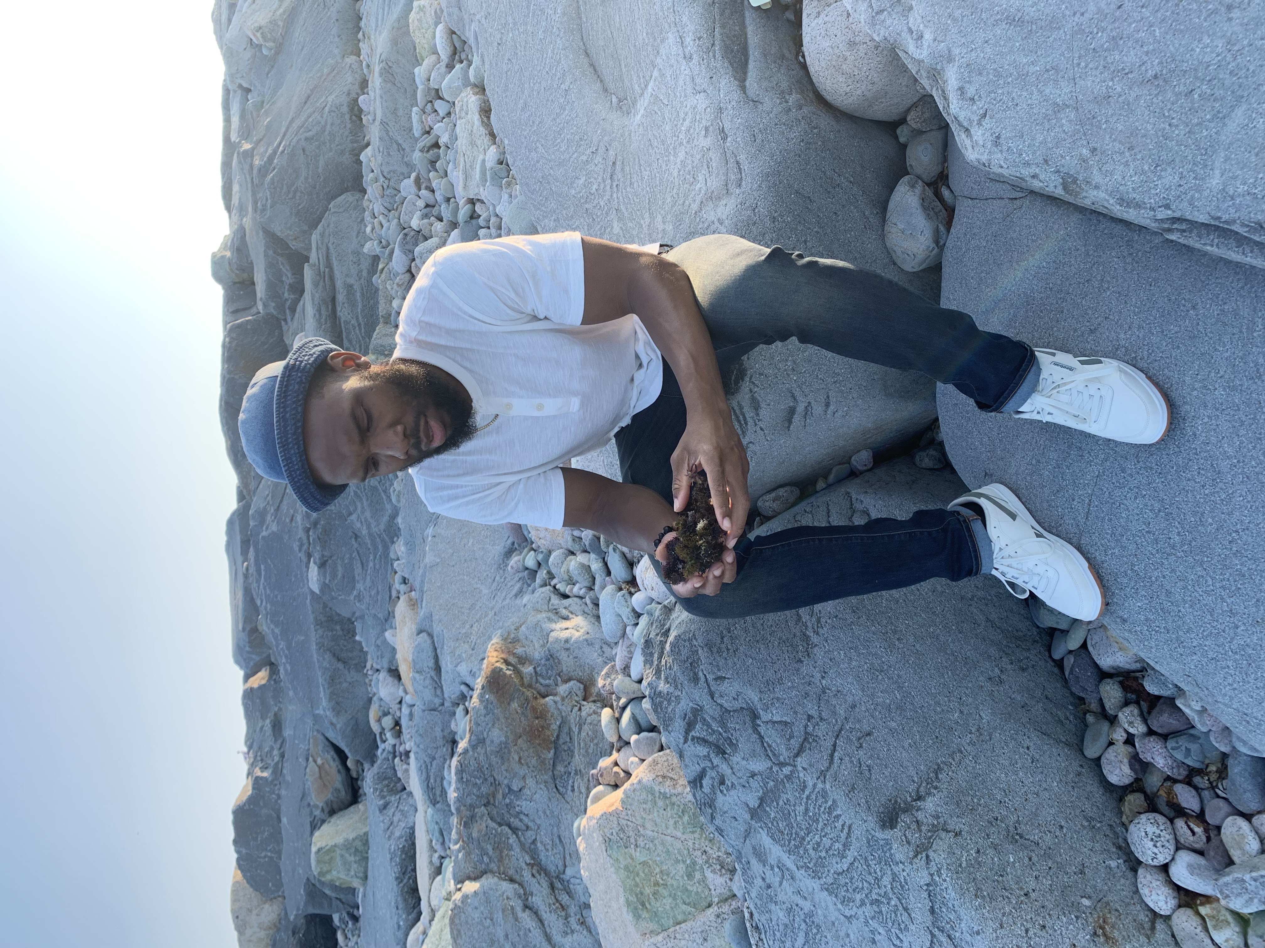 Shamar studying natural materials by the water